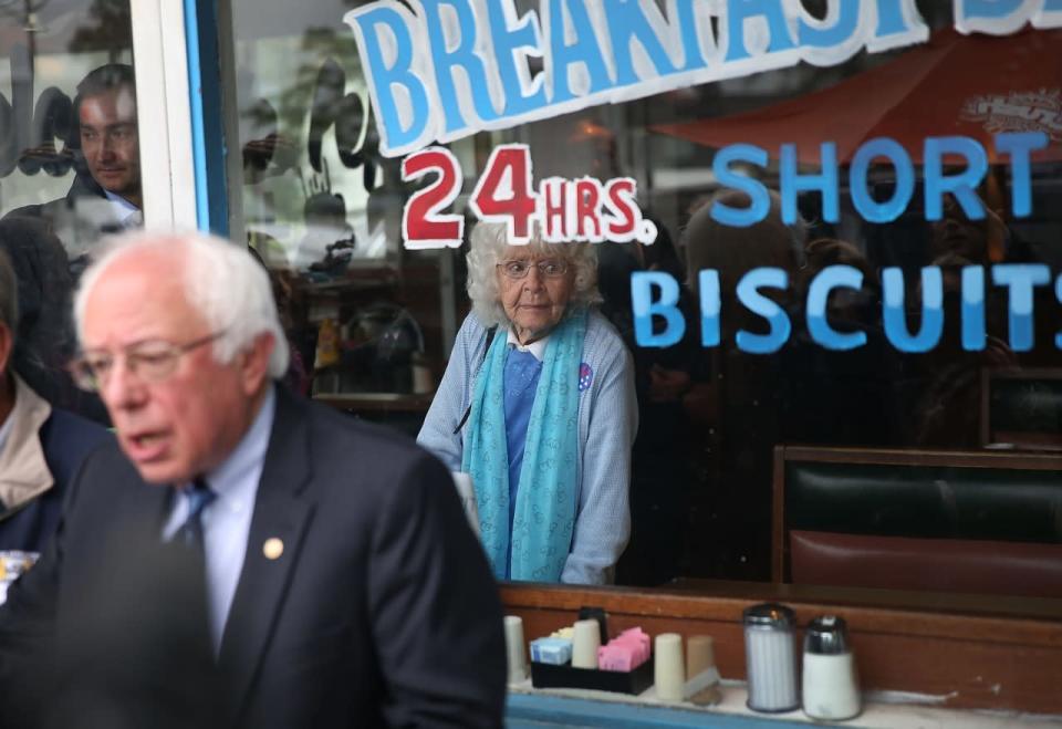 Madonna Rea looks out the window as Democratic presidential candidate Bernie Sanders speaks to the media during a stop for breakfast at Peppy’s Grill in Indianapolis. (Photo: Joe Raedle/Getty Images)