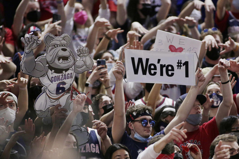 Spectators in the Gonzaga student section hold signs while watching the second half of the team's NCAA college basketball game against Santa Clara, Saturday, Feb. 19, 2022, in Spokane, Wash. Gonzaga won 81-69. (AP Photo/Young Kwak)