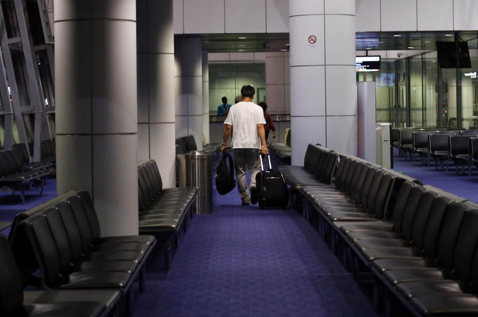 Passengers prepare to board the Malaysia Airlines Boeing 777-200ER flight MH318 to Beijing at the boarding gate at Kuala Lumpur International Airport