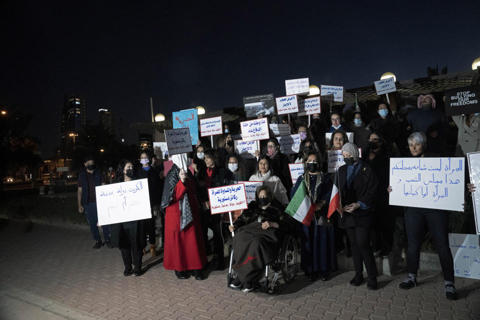 Women's rights activists and their supporters protest outside of Kuwait's National Assembly in Kuwait City, Monday, Feb. 7, 2022. Women might be progressing across the Arab world, but in Kuwait, the guardians of conservative morals have increasingly cracked down on their rights in recent months, prompting activists to take to the streets last week. (AP Photo/Maya Alleruzzo)