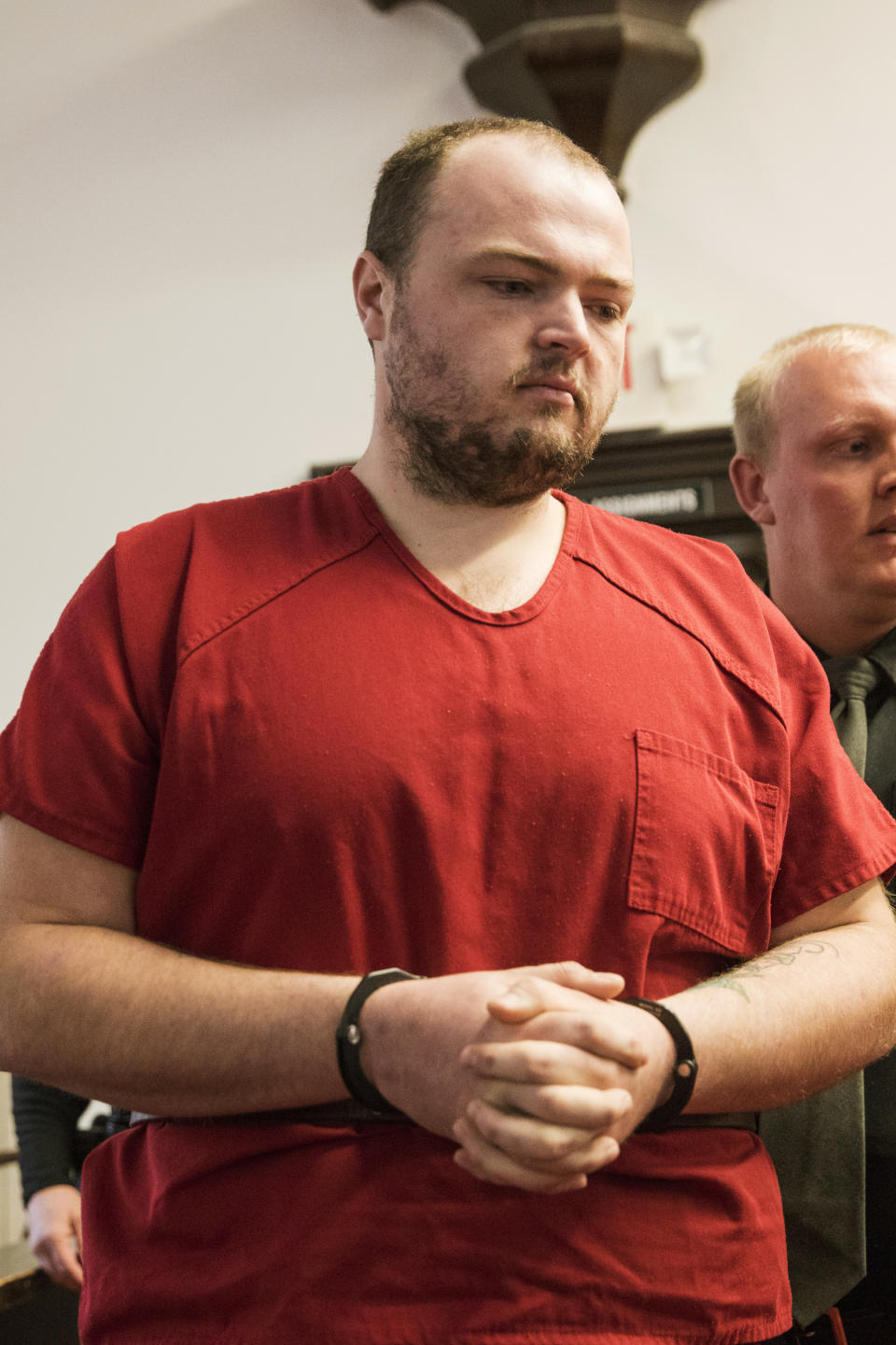 FILE—In this file photo from Nov. 28, 2018, George Wagner IV walks into the courtroom at the Pike County Courthouse for his arraignment in Waverly, Ohio. Wagner, his parents and brother were charged in the 2016 shootings of eight members of the Rhoden family. Ohio Judge Randy Deering on Wednesday Dec. 22, 2021, denied a request by lawyers for Wagner to dismiss his aggravated murder charges, thereby keeping the death penalty on the table for the man accused in the slayings of eight people from a single family. The lawyers said Wagner's brother, who pleaded guilty this year in the shootings, admitted to killing five of the victims and that George Wagner IV didn't kill anyone. (Robert McGraw//The Chillicothe Gazette via AP, Pool, File)