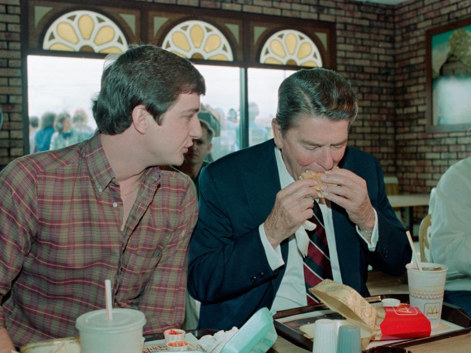 President Ronald Reagan takes a bite of a Big Mac, as Charles Patterson chats with him during a brief campaign stop in 1984