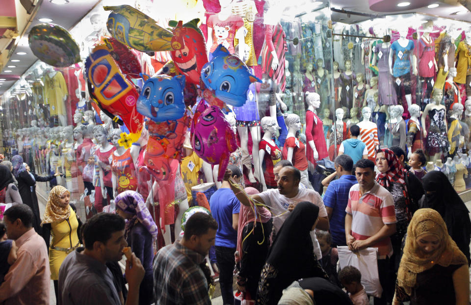 Egyptian crowd for shopping to mark Eid el-Fitr holiday, which caps the Muslim fasting month of Ramadan, in Cairo, Egypt late Wednesday, Aug. 15, 2012. (AP Photo/Amr Nabil)