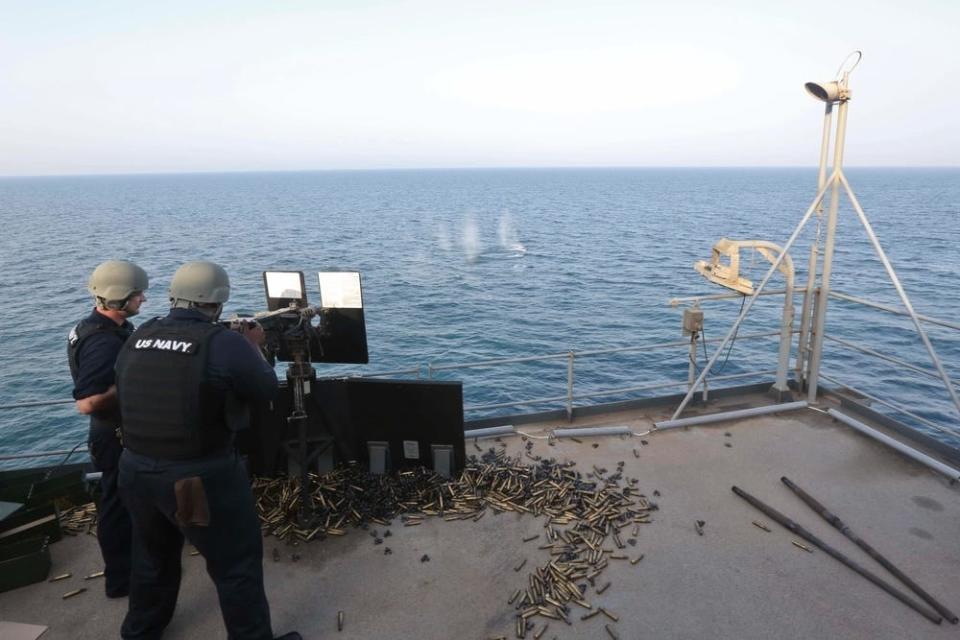 Sailors deployed aboard USS Lewis B. Puller fire a .50-caliber machine gun.