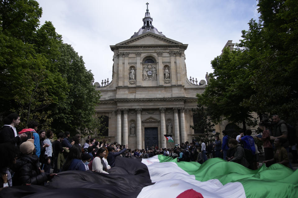 Students demonstrate outside La Sorbonne university with a huge Palestinian flag, Monday, April 29, 2024 in Paris. About 100 Pro-Palestinian students demonstrate near the Sorbonne university in Paris. The demonstration came on the heels of protests last week at another Paris-region school, Sciences Po. (AP Photo/Christophe Ena)