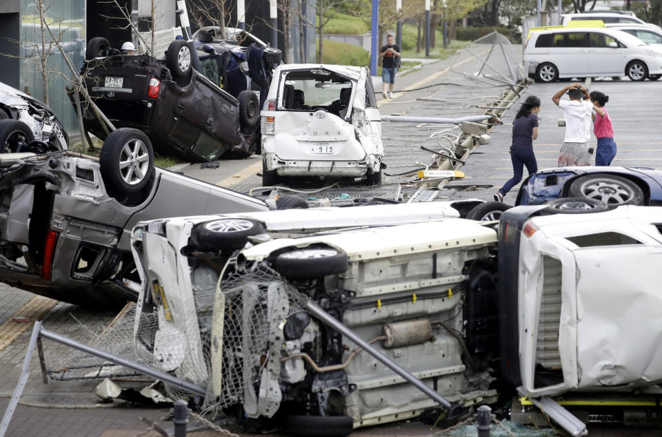 <em>Many cars were destroyed by either falling debris or being blown off the road. (Reuters)</em>