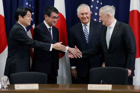 FILE PHOTO: (L-R) Japan's Defense Minister Itsunori Onodera and Foreign Minister Taro Kono shake hands with U.S. Secretary of State Rex Tillerson and Defense Secretary James Mattis before sitting down for U.S.-Japan Security talks at the State Department in Washington, U.S. August 17, 2017. REUTERS/Jonathan Ernst