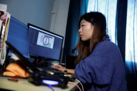 Game developer Wang Miaoyi works in her studio that is located in her appartment in Beijing, October 29, 2018.REUTERS/Thomas Peter