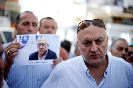 Majed Hattar (R), brother of the Jordanian writer Nahed Hattar, speaks to the media during a sit-in in the town of Al-Fuheis near Amman, Jordan, September 25, 2016. REUTERS/Muhammad Hamed