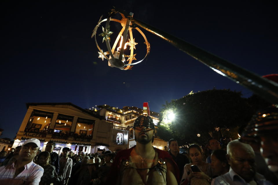 A man dressed as a Roman soldier participates in Holy Week celebrations in Taxco, Mexico, Thursday, April 18, 2019. In traditional processions that last from Thursday evening into the early morning hours of Friday, hooded penitents drag chains and shoulder the thorny bundles through the streets, as some flog themselves with nail-studded whips meant to bring them closer to God. (AP Photo/Rebecca Blackwell)