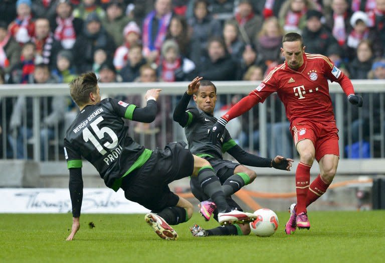 Bremen's defenders Theodor Gerbe Selassie and Sebastian Proedl (L) chalenge Bayern Munich's midfielder Franck Ribery (R) during their German first division Bundesliga football match in the southern German city of Munich on February 23, 2013. Bayern Munich rested half a dozen stars but still romped to a 6-1 win at home to 10-man Werder Bremen to go 18 points clear at the top of the Bundesliga