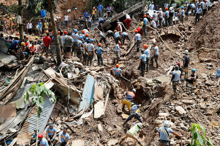 Rescuers search for people trapped in a landslide, after super typhoon Mangkhut hit the country, at a mining camp in Itogon, Benguet, Philippines September 17, 2018. REUTERS/Erik De Castro