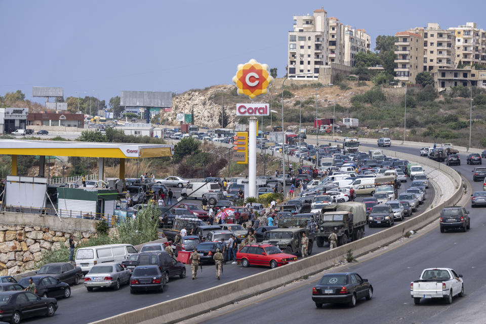 FILE - In this Sept. 3, 2021, file photo, cars line up at a petrol station as they try to get gas on the main highway in the coastal town of Jiyeh, south of Beirut, Lebanon. Countries like Lebanon, Syria, Iraq, Lebanon and Yemen are all teetering on the brink of humanitarian catastrophe with an economic implosion that threatens to throw the region into even deeper turmoil. (AP Photo/ Hassan Ammar)