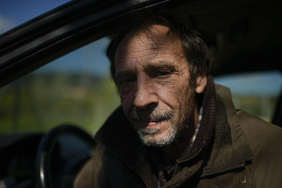 Juan Jimenez, 60, sits in his car which is now his home, in Pamplona, northern Spain, Wednesday, March 17, 2021. Jimenez has been forced to dwell in his second-hand Ford for close to a year after seeing his life collapse when he and his wife bought a bigger house, only for mortgage payments to spiral out of control and for their marriage to crumble after the economic slowdown caused by the coronavirus pandemic destroyed his financial stability. (AP Photo/Alvaro Barrientos)