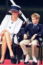 <p>Harry takes his shoes off at the V-J Day 50th anniversary celebrations in London with Princess Diana. </p>