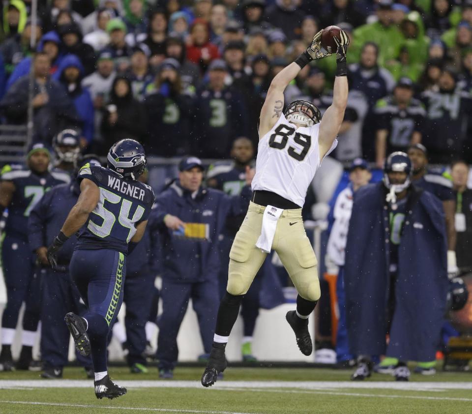 New Orleans Saints tight end Josh Hill, right, catches a pass next to Seattle Seahawks middle linebacker Bobby Wagner (54) during the second half of an NFC divisional playoff NFL football game in Seattle, Saturday, Jan. 11, 2014. (AP Photo/Ted S. Warren)