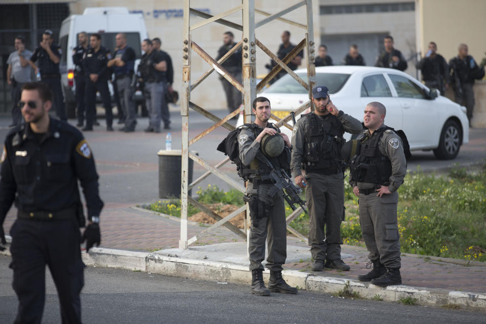 Israeli border police officers stand at the entrance to Sharon prison, near Raanana, central Israel, Sunday, Feb. 23, 2014. Israeli police say a SWAT team has killed an inmate who had seized a guard's weapon and shot three guards. Police spokesman Micky Rosenfeld said Sunday that the inmate, who was serving a long sentence for murder, had barricaded himself after shooting the guards. A standoff ensued, with counter-terrorism units dispatched to the scene. The inmate then opened fire again, he said, before the forces shot him dead. Of the three guards shot, two were seriously wounded, thrid was lightly wounded. The prisoner was not officially identified, but Israeli media reports identified him as Samuel Sheinbein, an American who fled to Israel after committing a murder in Maryland in 1997. (AP Photo/Ariel Schalit)