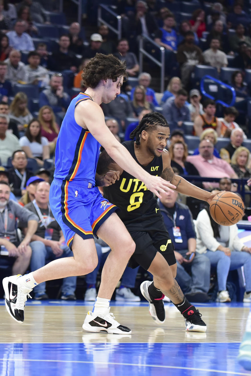 Utah Jazz forward Brice Sensabaugh, right, drives past Oklahoma City Thunder guard Josh Giddey, left, in the second half of an NBA basketball game, Wednesday, March 20, 2024, in Oklahoma City. (AP Photo/Kyle Phillips)