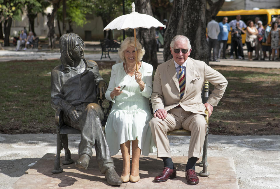 Charles and Camilla sit on the John Lennon memorial bench in Havana, Cuba in 2019 