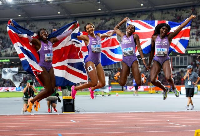 From left to right, holding individual Union Jacks flags and jumping in the air, Great Britain’s Asha Philip, Imani-Lara Lansiquot, Bianca Williams and Daryll Neita celebrate after finishing third in the Women’s 4×100 Metres Relay Final on day eight of the World Athletics Championships at the National Athletics Centre in Budapest, Hungary