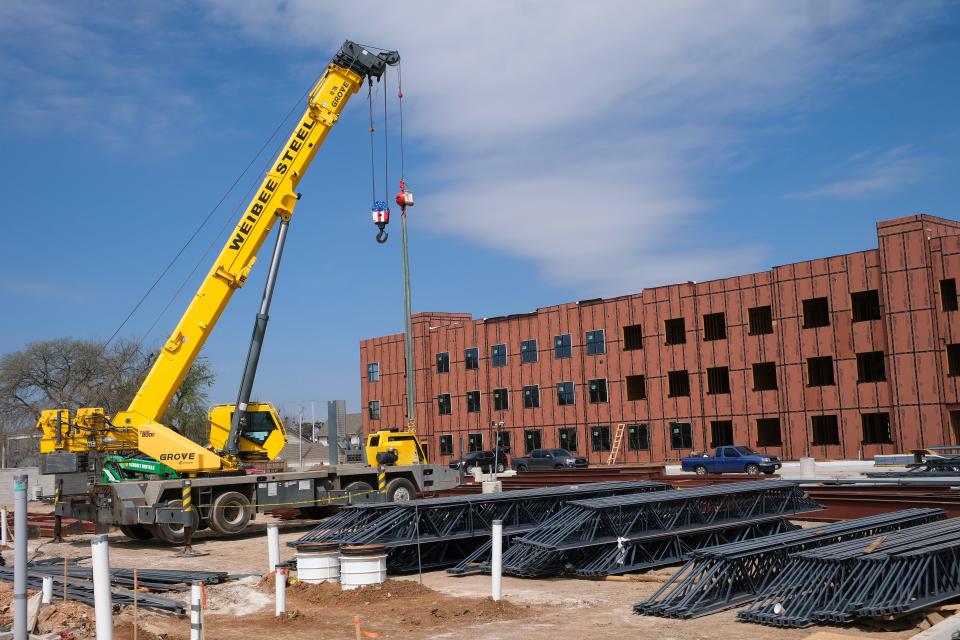 Workers prepare to erect a steel frame for the southernmost building that will be part of The Campbell next to the University of Central Oklahoma's campus.