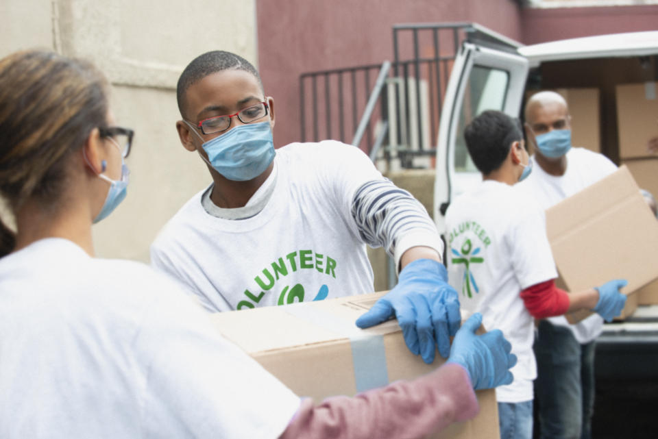 Group of volunteer people delivering boxes