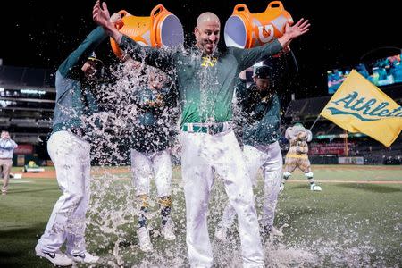 May 7, 2019; Oakland, CA, USA; Oakland Athletics starting pitcher Mike Fiers (50) is dunked after pitching a no hitter against the Cincinnati Reds at Oakland Coliseum. Mandatory Credit: Stan Szeto-USA TODAY Sports