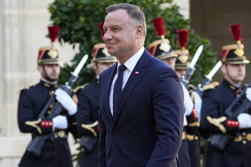 Poland's President Andrzej Duda walks past Republican Guards as he arrives at the Elysee Palace Wednesday, Oct. 27, 2021 in Paris. The European Union's top court has ordered Poland to pay 1 million euros a day ($1.2 billion) over the country's longstanding dispute with the bloc over judicial independence. (AP Photo/Michel Euler)