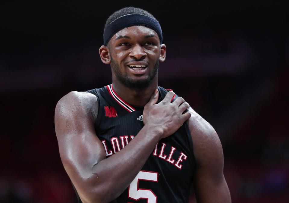 Louisville basketball's Brandon Huntley-Hatfield (5) grabbed his shoulder as he headed to the bench during their game against Virginia Tech at the KFC Yum! Center in Louisville, Ky. on Mar. 5, 2024.
