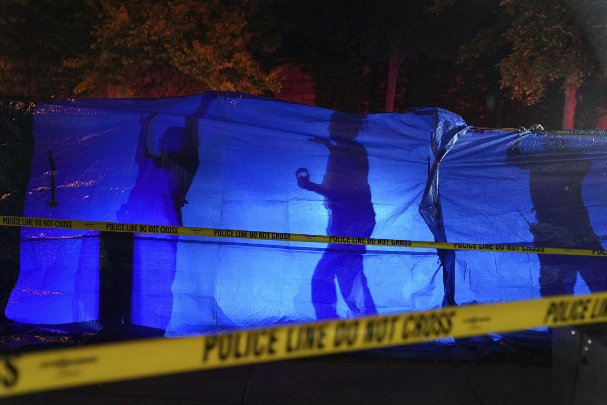 Police put up a blue tarp to block the view of a body at the scene of an officer involved shooting  in Richfield, Minn., Saturday night, Sept. 7, 2019. Police near Minneapolis shot and killed a driver following a chase after he apparently emerged from his car holding a knife and refused their commands to drop it. The chase started late Saturday night in Edina and ended in Richfield with officers shooting the man, Brian J. Quinones, who had streamed himself live on Facebook during the chase. (Anthony Souffle/Star Tribune via AP)