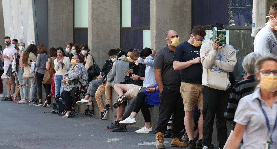 People line up outside the Royal Melbourne Hosital for coronavirus testing in Melbourne, Tuesday, March 10, 2020. (AAP Image/David Crosling) NO ARCHIVING