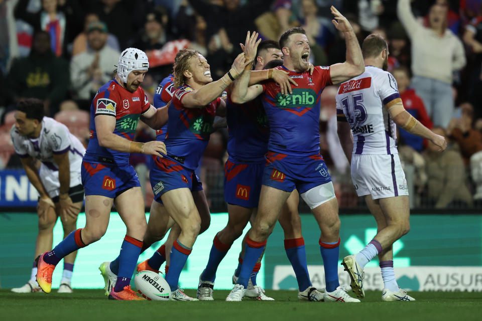 Newcastle Knights players celebrate a try.