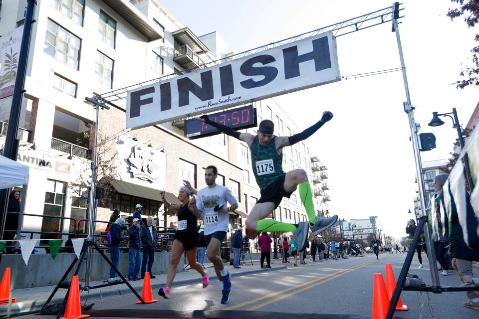 Tallahassee Marathon runners react as they cross the finish line Sunday, Feb. 2, 2020.