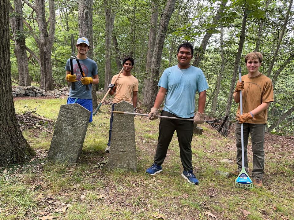 Mahwah Boy Scout Peter "Kaya" Gretchikha (right) with volunteers clearing the cemetery area.