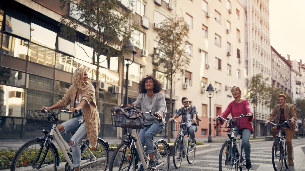 friends riding bicycles in a city