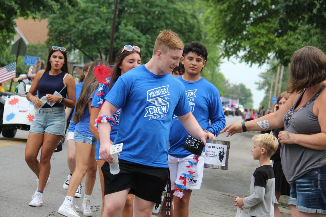 Members of the Perry High School Class of 2024 collect money through the Bucket Brigade during the Fourth of July parade on Monday, July 4, 2022, in Perry.