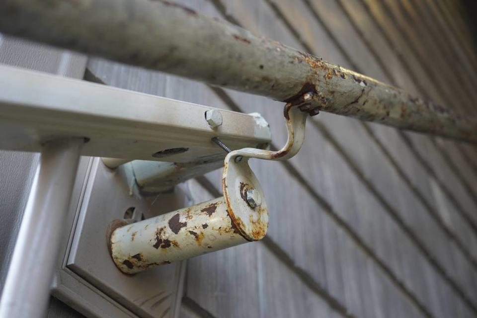An unstable railing is rusted and held up by a screw at the Meadow Wood Townhomes on Sept. 22, in Bellingham, Washington. Rachel Showalter/The Bellingham Herald