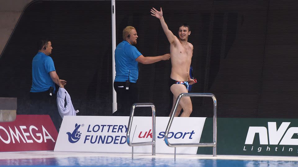 The prankster waves to the crowd, but appears to be the only one impressed by his impromptu plunge. Photo: Getty