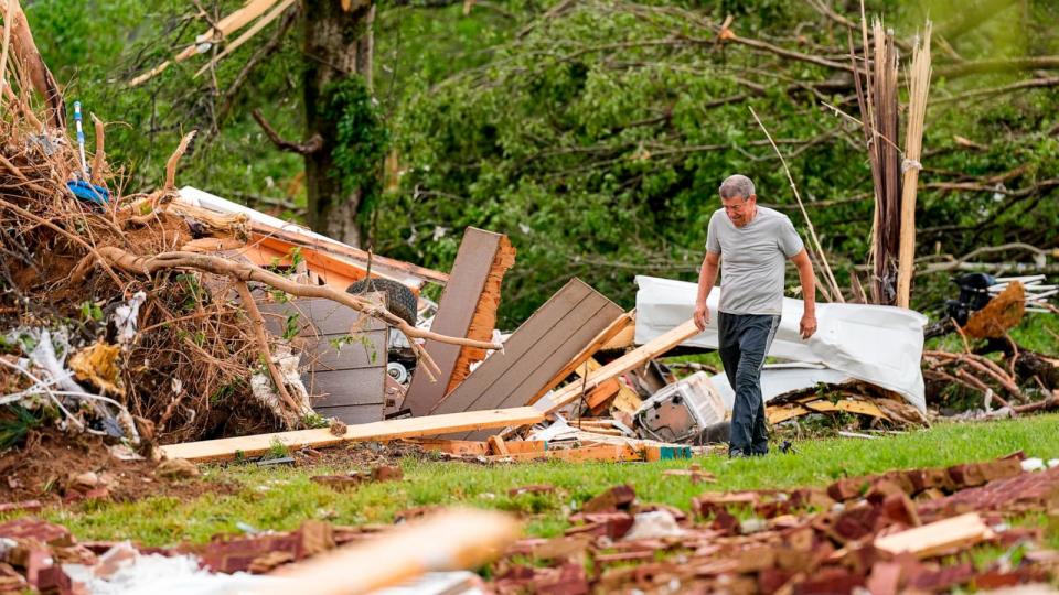PHOTO: John Bernhardt searches for his belongings outside his storm-damaged home Thursday, May 9, 2024, in Columbia, Tenn.  (George Walker IV/AP)
