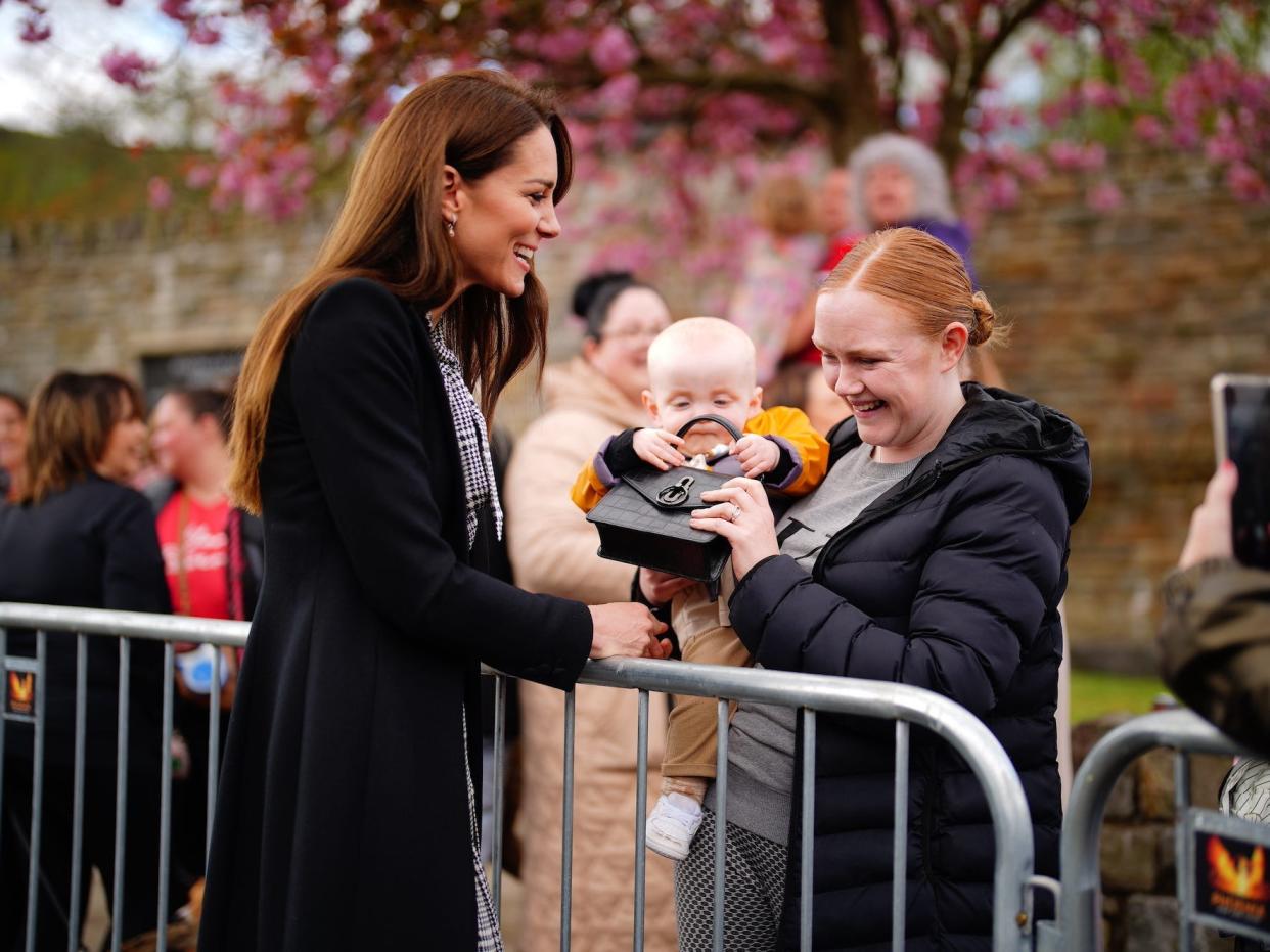 Kate Middleton speaks to a mother and her baby at the Aberfan memorial garden in April 2023.