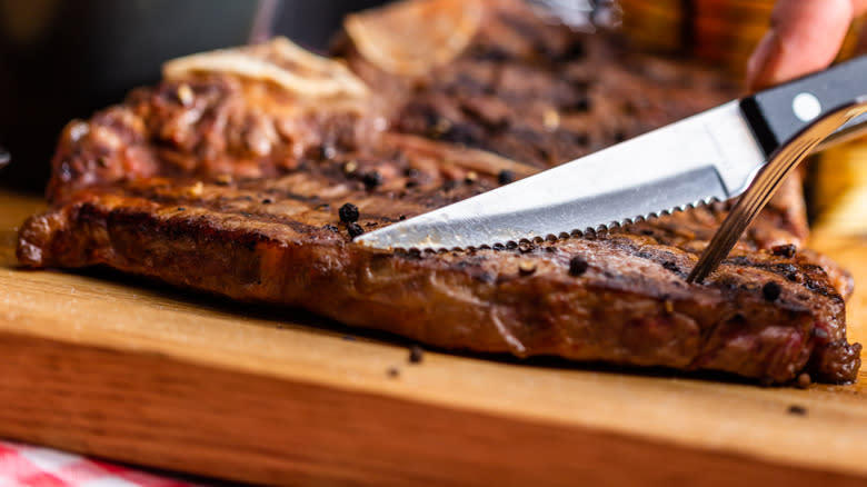 Steak knife cutting steak