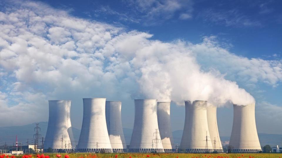 Nuclear Power plant with red field and blue sky