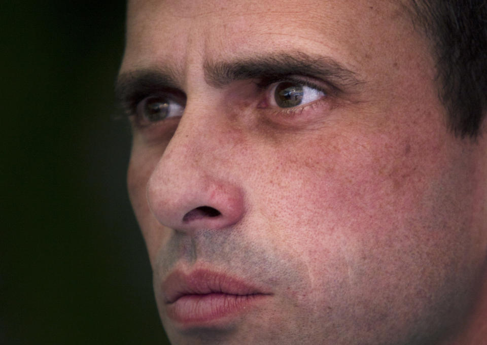 FILE - In this Tuesday Feb. 7, 2012 file photo, presidential opposition candidate Henrique Capriles listens to a question during a news conference, in Caracas, Venezuela. Venezuela's President Hugo Chavez finds himself ailing as he heads into a re-election campaign against Capriles, a 39-year-old state governor who represents a younger and more energetic option, said Diego Moya-Ocampos, an analyst with the London-based consulting firm IHS Global Insight. (AP Photo/Ariana Cubillos, File)