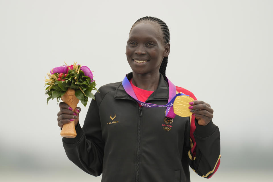 Gold medalist Bahrain's Eunice Chebichii Paul Chumba celebrates on the podium during the victory ceremony for the women's marathon at the 19th Asian Games in Hangzhou, China, Thursday, Oct. 5, 2023. (AP Photo/Lee Jin-man)