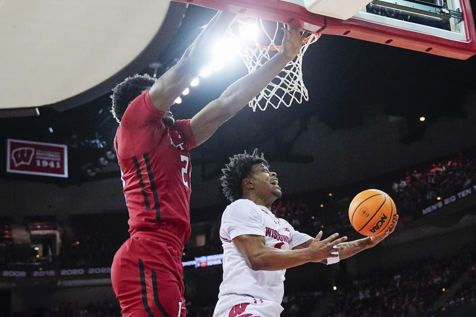 Wisconsin's Kamari McGee (4) shoots against Rutgers' Emmanuel Ogbole (22) during the second half of an NCAA college basketball game Thursday, March 7, 2024, in Madison, Wis. (AP Photo/Andy Manis)