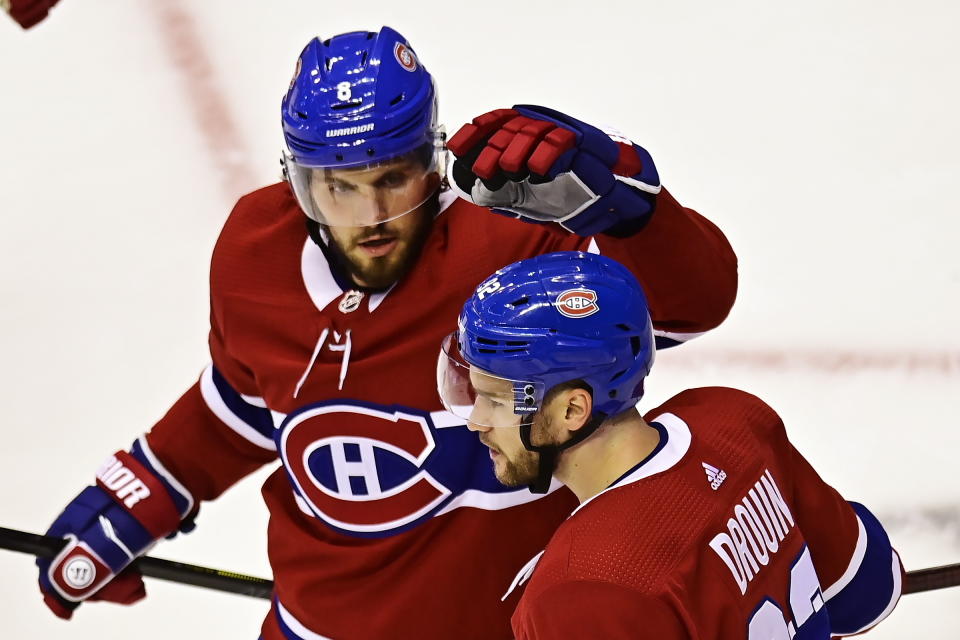 Montreal Canadiens' Jonathan Drouin (92) is congratulated by Ben Chiarot (8) after scoring against the Pittsburgh Penguins during the second period of an NHL hockey playoff game Wednesday, Aug. 5, 2020 in Toronto. (Frank Gunn/The Canadian Press via AP)