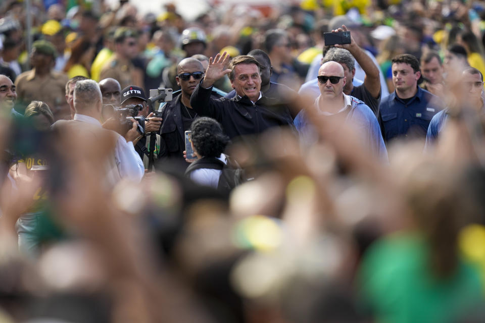 Brazil's President Jair Bolsonaro greets supporters upon his arrival to a military display and rally to celebrate the bicentennial of the country's independence from Portugal, in Rio de Janeiro, Brazil, Wednesday, Sept. 7, 2022. (AP Photo/Silvia Izquierdo)