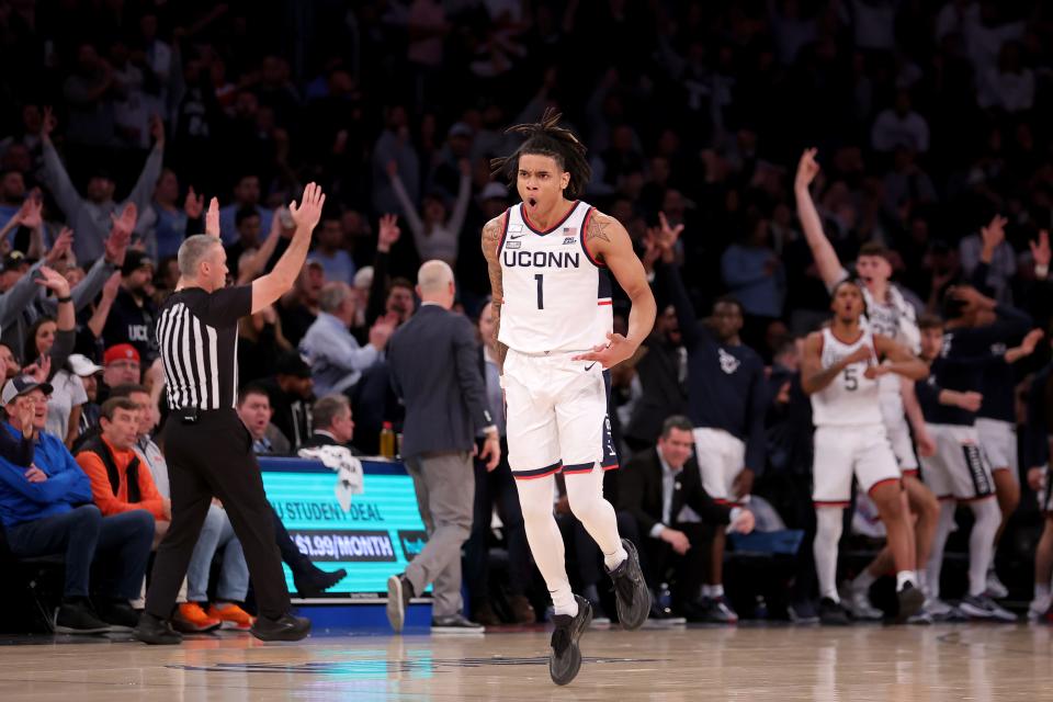 Connecticut guard Solomon Ball (1) celebrates his 3-point shot against North Carolina on Tuesday at Madison Square Garden in New York. The Huskies won, 87-76.