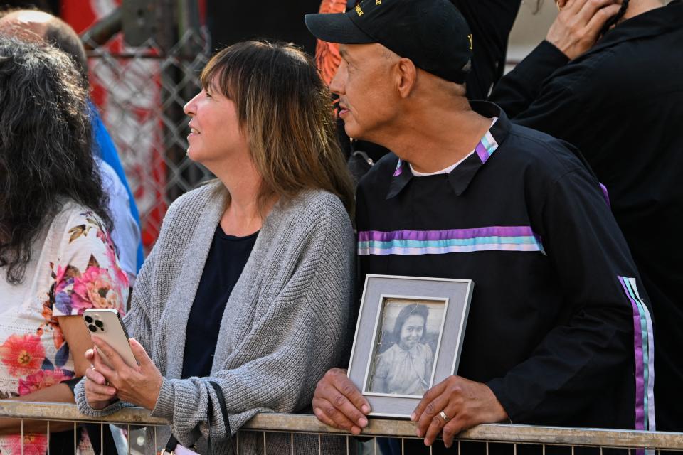 Gerald Gladue holds a photo of his mother, Jeannie Gladue, a residential school survivor, while waiting for Pope Francis to arrive at the Sacred Heart Church of the First Peoples, where he met with members of the Indigenous community in Edmonton on Monday. 