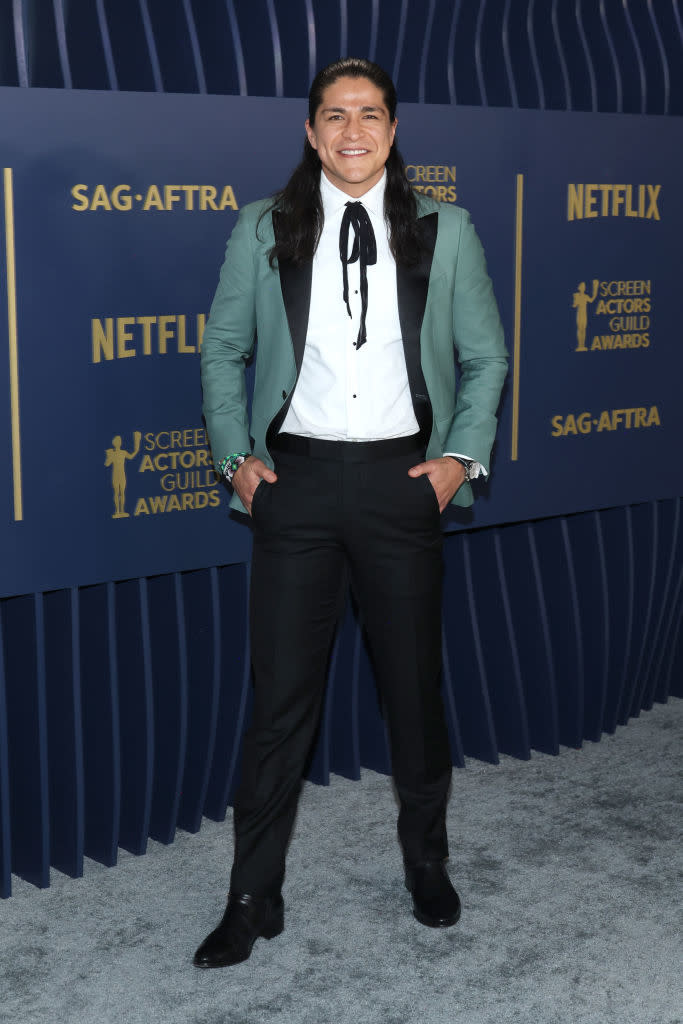 Cristo Fernández in a tailored suit with bow